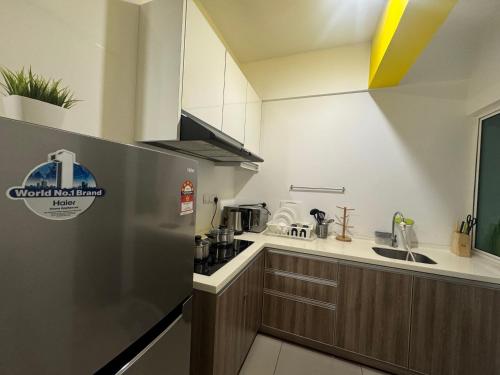 a kitchen with a stainless steel refrigerator and a sink at The Majestic Imperial Tower Premium Suite - Ipoh in Ipoh