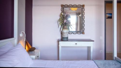 a bedroom with a bed and a mirror on the wall at Ionian Kaizer Boutique in Achílleion