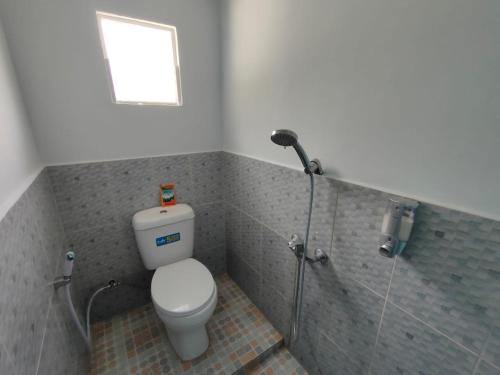 a bathroom with a toilet and a shower at Villa harapan baru in Berastagi
