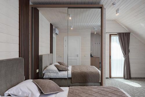 a bedroom with two beds and a mirror at Hotel Podgorie Spa in Bukovel
