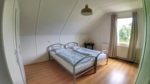 a bedroom with a bed in a room with a window at Camping Prima in Týn nad Vltavou