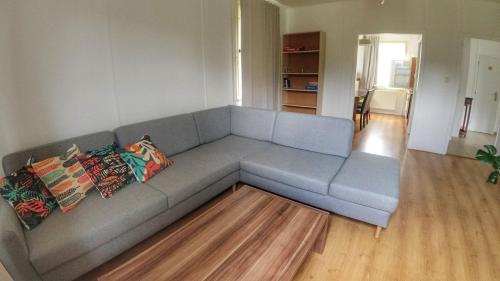 a living room with a blue couch with pillows at Camping Prima in Týn nad Vltavou