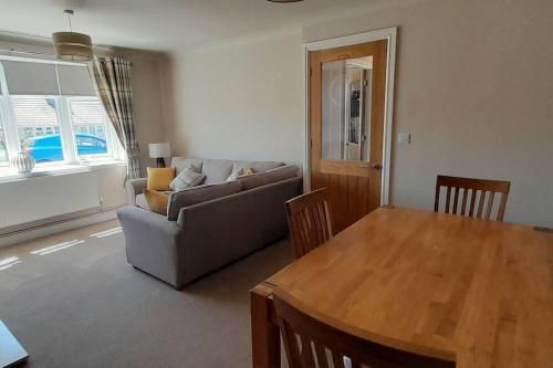 a living room with a couch and a table at Remarkable 2-Bed House in Walesby Nottinghamshire in Elkesley