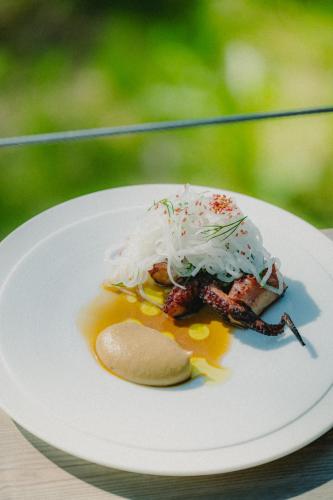 a white plate with food on a table at Lahepere Villa mini-villad in Kloogaranna