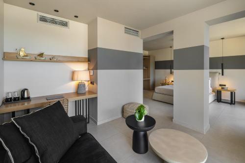 a living room with a couch and a table at Asteris Hotel in Skala Kefalonias