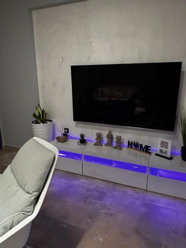 a living room with a large flat screen tv at George luxury living in Preveza