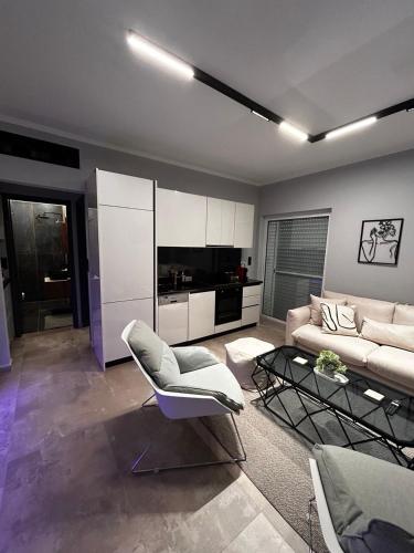 a living room with a couch and a table at George luxury living in Preveza