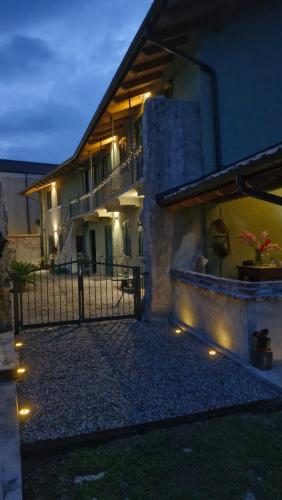 a house with lights on the side of it at night at Casa il Grappolo in Momo