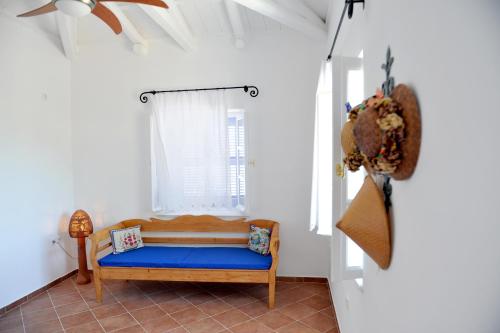 a bedroom with a blue bed in a room at Hydra Erato in Hydra