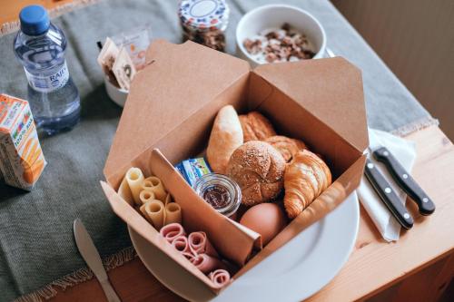 a box of bread and pastries on a table at U staré cesty in Horní Slavkov