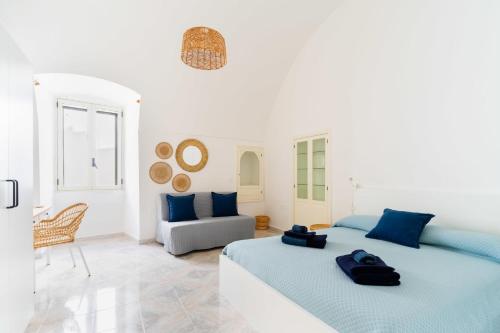 een witte kamer met 2 bedden en een bank bij BluMarine by Vivimy in Gallipoli