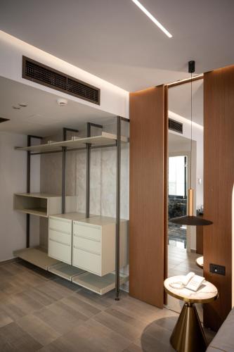 a room with a closet with shelves and a table at Brilliant Hotel & SPA in Golem