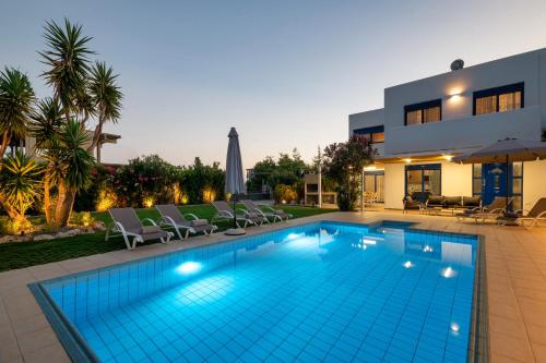 a swimming pool in front of a house at Villa Mariani II - in Lothiarika, newly renovated June 2024, private pool, Lindos 10 min, beach 120m in Lardos