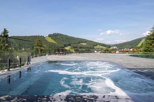 a pool of water with snow on the ground at Hotel Podgorie Spa in Bukovel