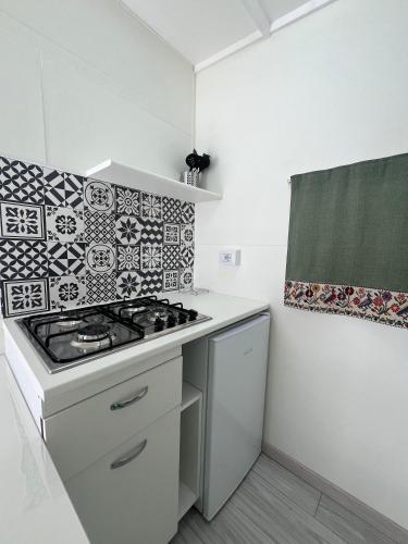 a kitchen with a stove top oven in a room at Camping Car Palmasera in Cala Gonone