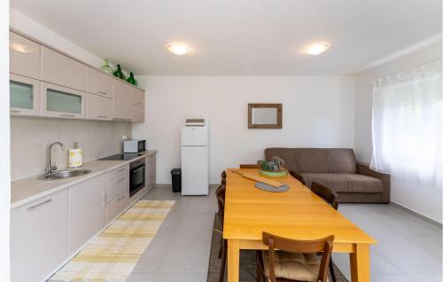a kitchen and living room with a table and a couch at 3 Bedroom Amazing Home In Sukosan in Sukošan