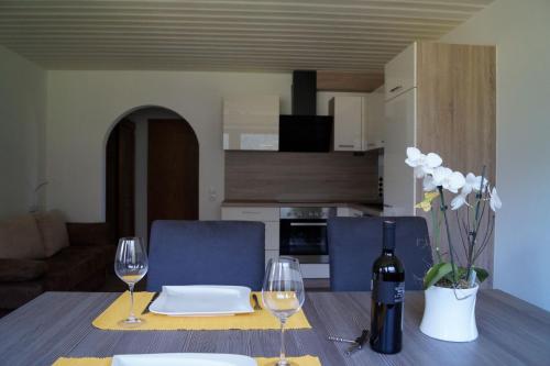 a table with two wine glasses and a bottle of wine at Pension Riese in Neustift im Stubaital