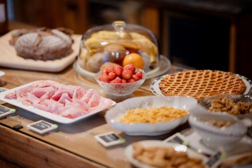 a table with different types of food on it at La Caso Di Elva in Elva