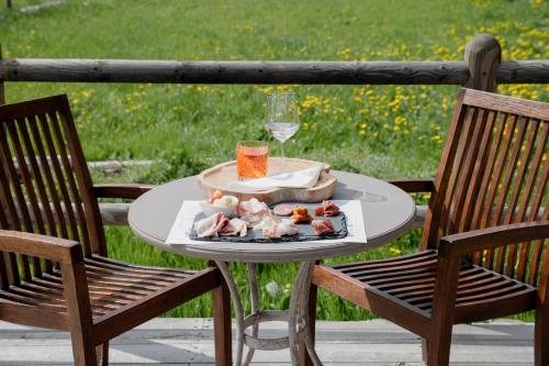 a table with a plate of food and a glass at La Caso Di Elva in Elva