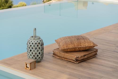 a table with three towels and a vase on it at Casa Picimenti Zakynthos Marathias Swimming Pool Ground Floor Villa in Marathias