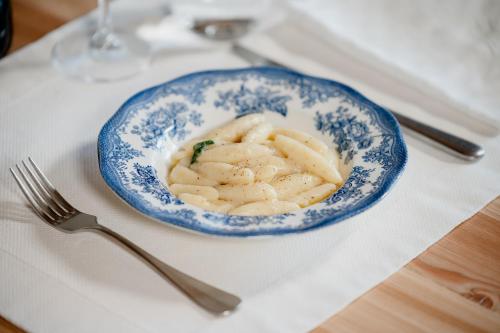 a plate of pasta on a table with a fork at La Caso Di Elva in Elva