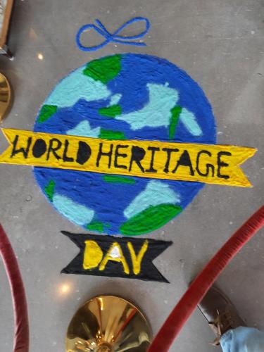 a sign that reads world heritage day with a drawing of the earth at Efcee Sarovar Premiere Bhavnagar in Bhavnagar