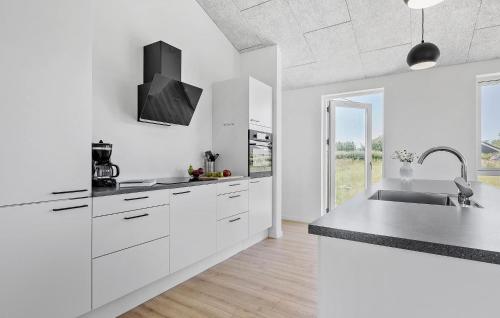 a white kitchen with white cabinets and a sink at 3 Bedroom Cozy Home In Slagelse in Slagelse