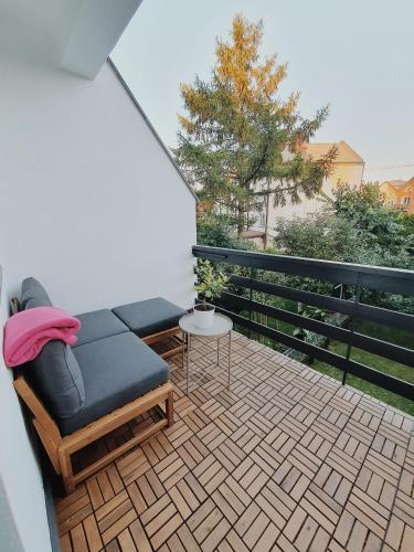 a balcony with a couch and a table at Willa Tradycja 2 in Gdańsk