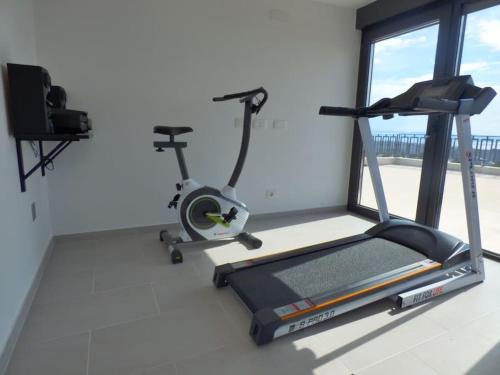 a room with a gym with a treadmill and a window at Villa Martina Bellevue in Šmrika