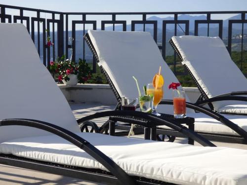 two chairs with drinks on them on a patio at Villa Martina Bellevue in Šmrika