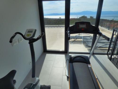 a view of a gym with a treadmill and a window at Villa Martina Bellevue in Šmrika
