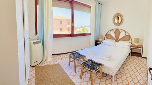 a bedroom with a bed and a large window at Casa Rea in Francavilla al Mare