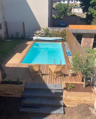 une piscine avec deux chaises et une table dans l'établissement Center house with swimming pool, à Brive-la-Gaillarde