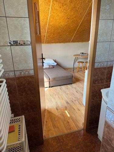 a small room with a bed and a table at Zefirek in Stegna
