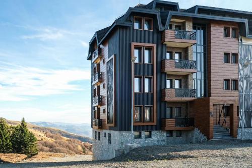 a building on the side of a mountain at Vila Golija Peak Suites in Kopaonik