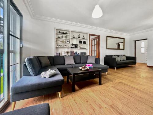 a living room with a couch and a table at Villa San Patricio I Piscina Privada I Jacuzzi Spa I BBQ I PS5 I Aire Acon I 3000m2 I 5min-Centro in Jerez de la Frontera
