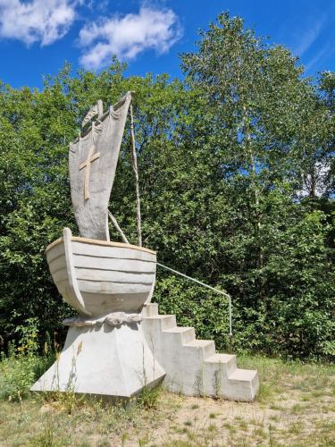 a statue of a boat with a cross on it at Wiele Żurawi in Wiele