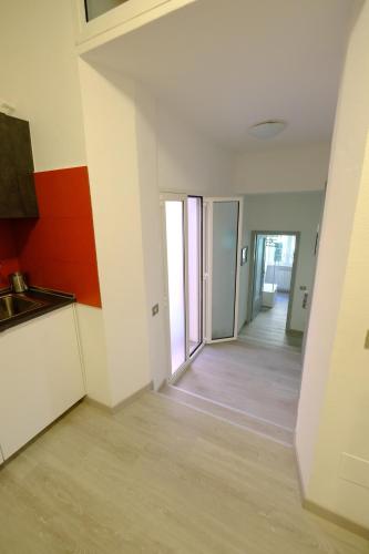 an empty room with a kitchen and a hallway at Casa Maggiolino by PortofinoVacanze in Rapallo