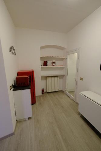 an empty room with a red refrigerator and a door at Casa Maggiolino by PortofinoVacanze in Rapallo