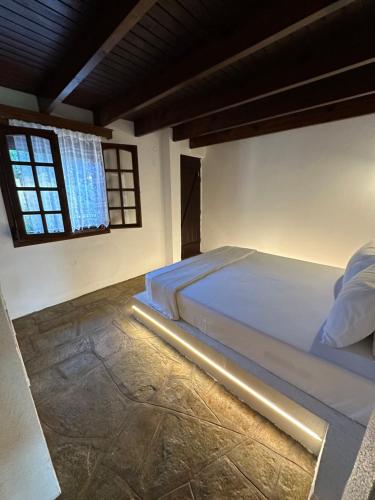 a bedroom with a large bed with a window at Ήλιος Villa in Ktima Gerostathi in Polykhrono
