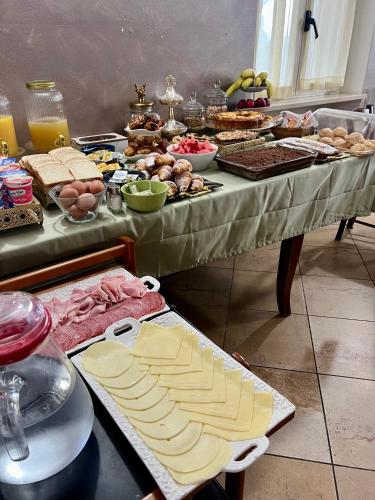 a table filled with cheese and other food on it at Albergo quatro pini in Pozzolengo