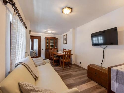 a living room with a couch and a television at da Adri ed Eli in Anzino