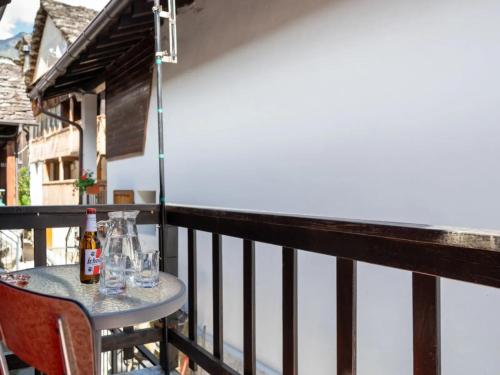 a table with glasses and bottles on a balcony at da Adri ed Eli in Anzino