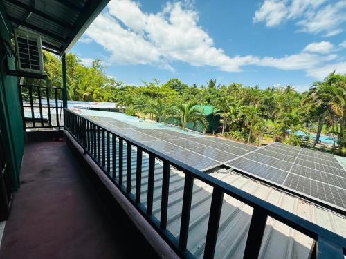 a tennis court with solar panels on a balcony at Tishan Holiday Resort in Polonnaruwa