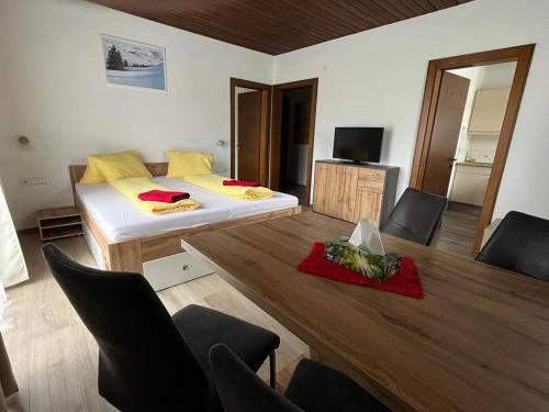 a room with a bed and a table and chairs at Pension Steiner, 6143 Matrei am Brenner!!Check-in between 15 - 21 o'clock!! No breakfast in Mühlbachl