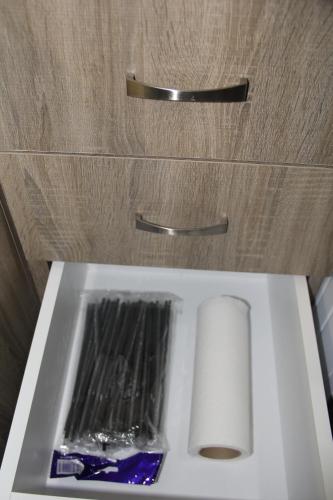 a white sink with a roll of toilet paper on it at Apartment Patra Greece in Patra