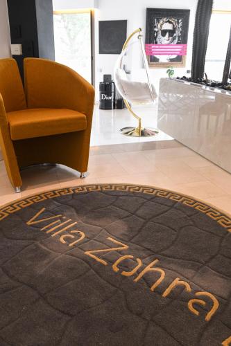 a rug with the words happy new year on a floor next to a chair at Superbe villa avec piscine intérieure, sauna, jacuzzi et salle de sport in Lucinges