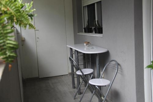 a small white table and chairs in a room at Apartment Patra Greece in Patra