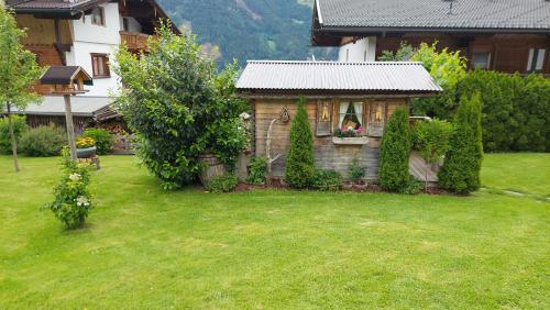 a small house in the middle of a yard at Gästehaus Christoph in Ried im Zillertal