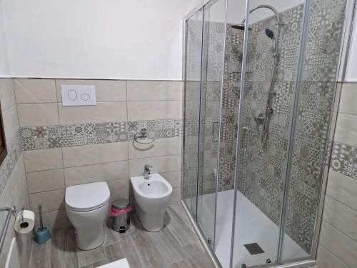 a bathroom with a shower and a toilet and a sink at Turre in Scano Montiferro